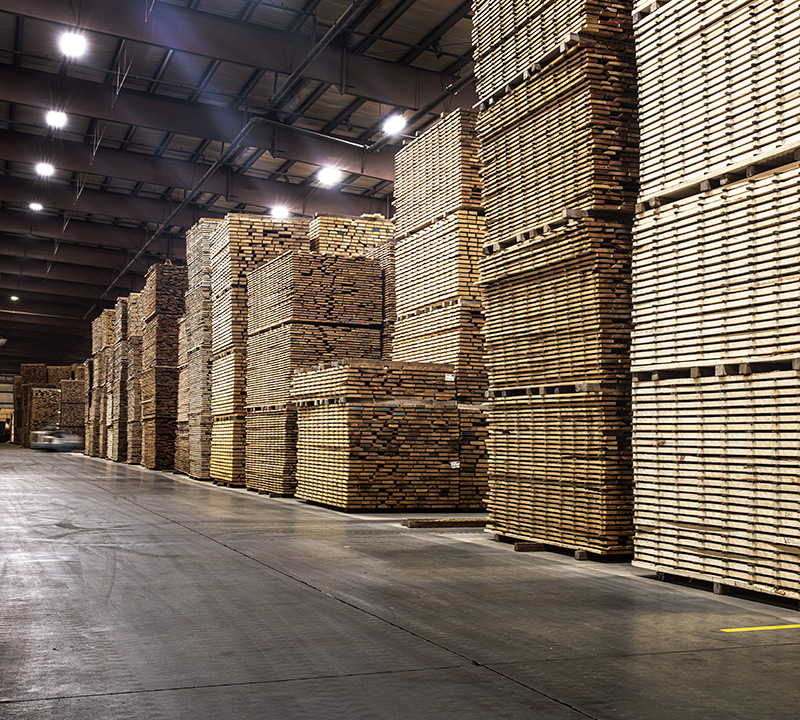 stacks of cut lumber standing in a Granite Valley Forest Products warehouse