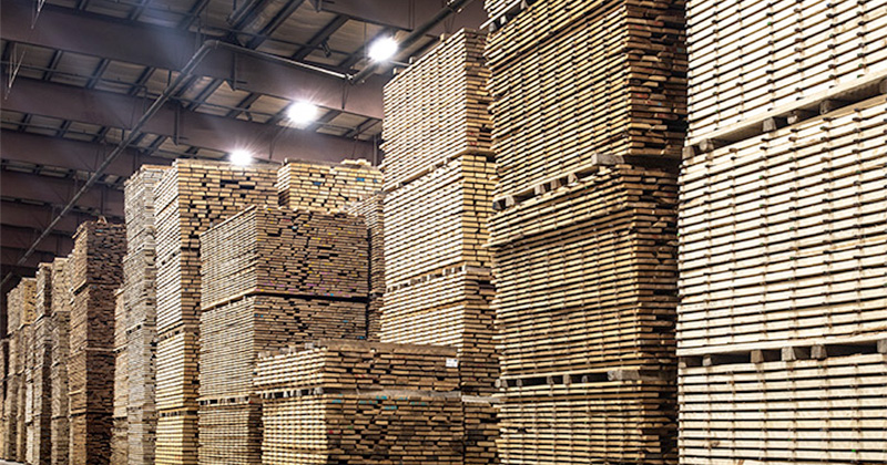 stacks of cut lumber standing in a Granite Valley Forest Products warehouse